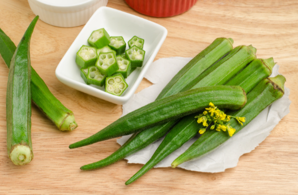 Okra vegetables partially cut on a table.